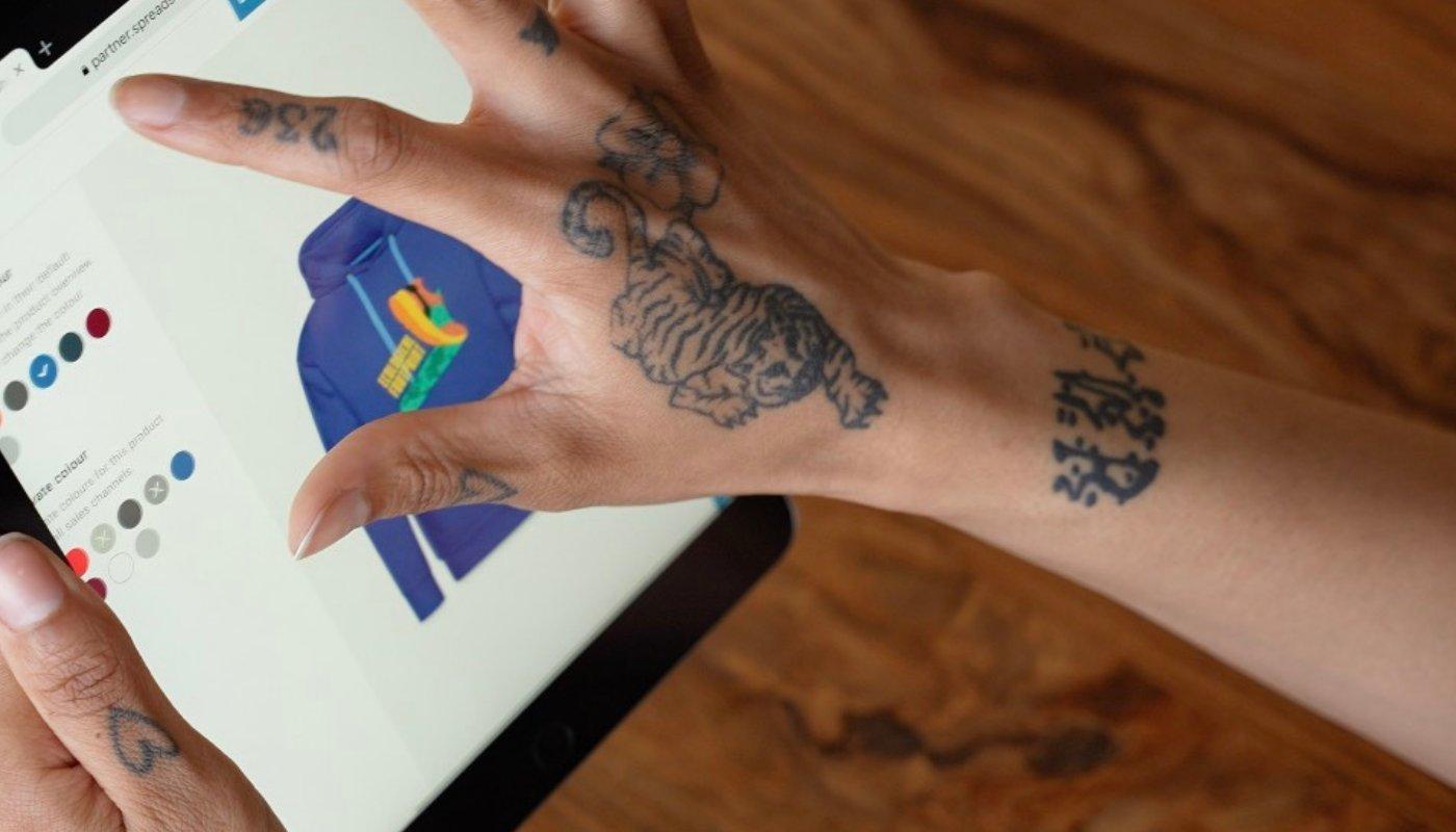 person making their own hoodie to sell